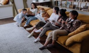 Happy Family Sitting on the Couch while Spending Time Together